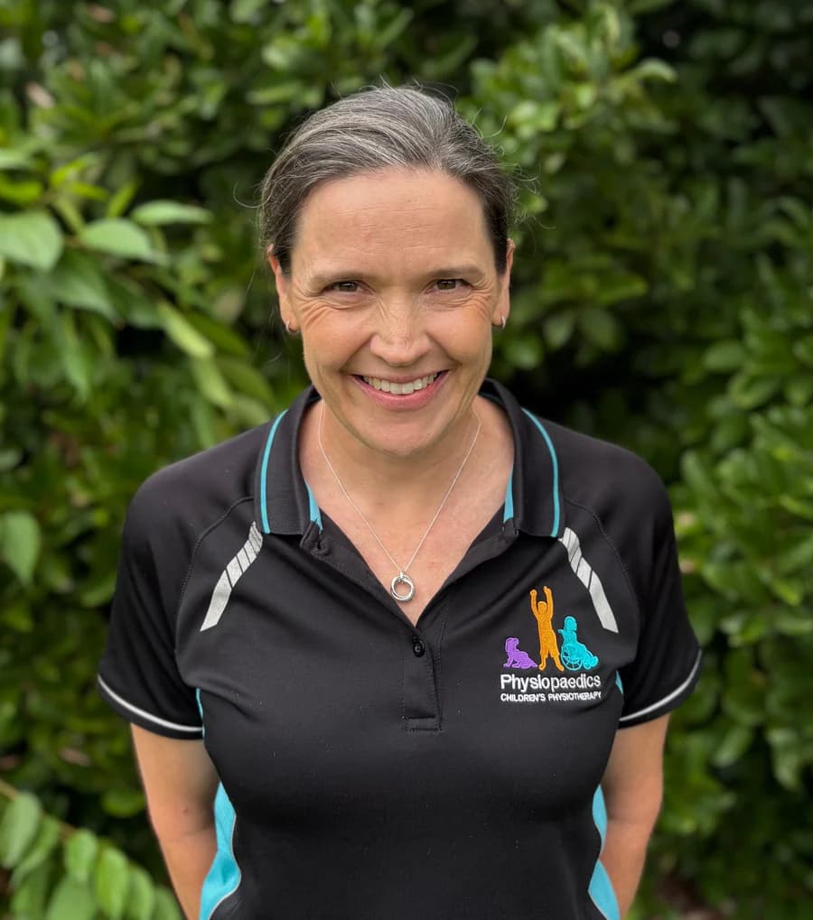 Anne Kelly, smiling, in her Physiopaedics polo