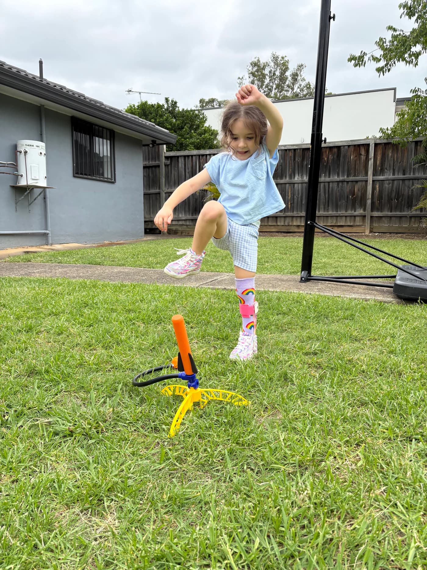 A girl stomping on a stomp rocket in the clinic's backyard